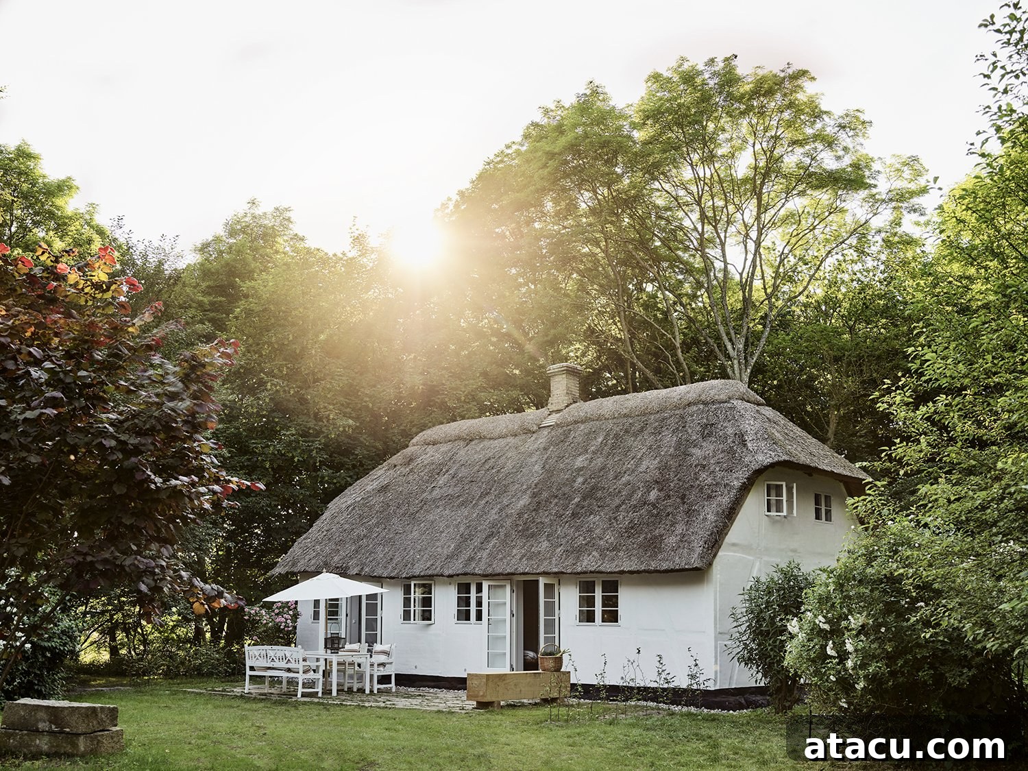 Vipp Farmhouse exterior, a traditional Danish thatched roof building surrounded by lush nature on Lolland Island