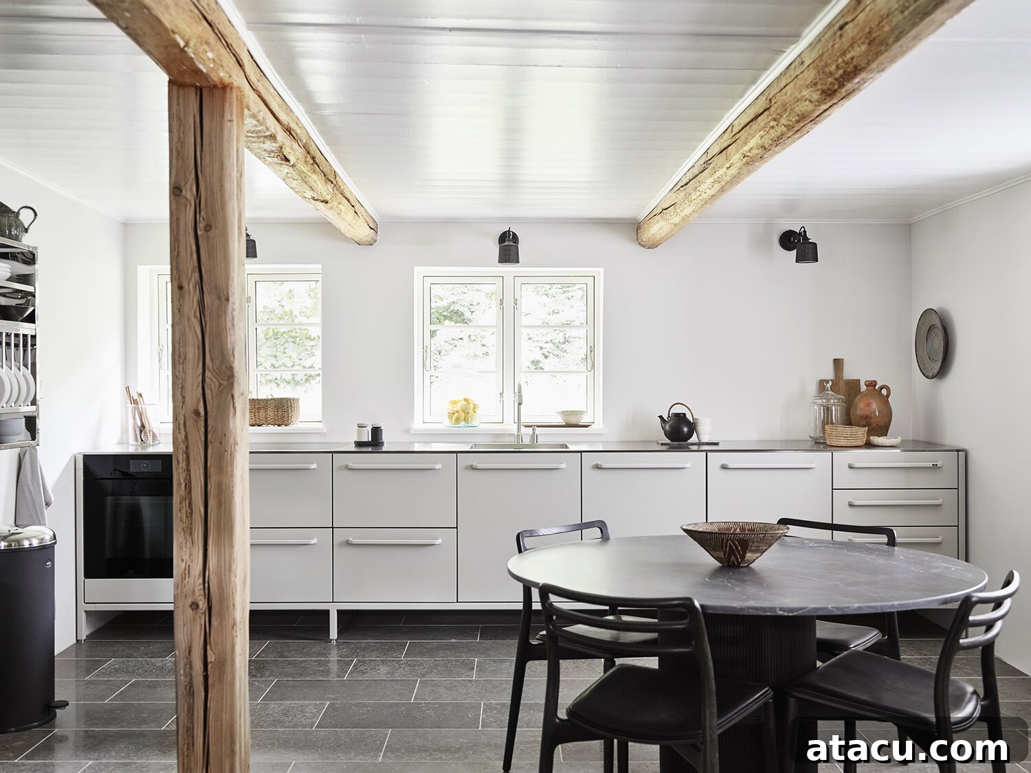 Vipp Farmhouse kitchen island and dining area, showcasing sleek lines and practical elegance