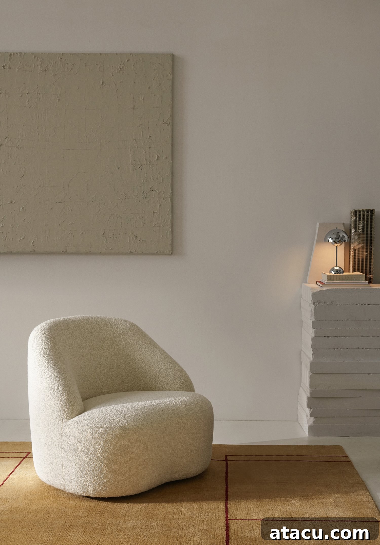 Elegant Margas Lounge Chair by Louise Liljencrantz, featuring a curved frame and oak or walnut legs, in a modern interior setting.