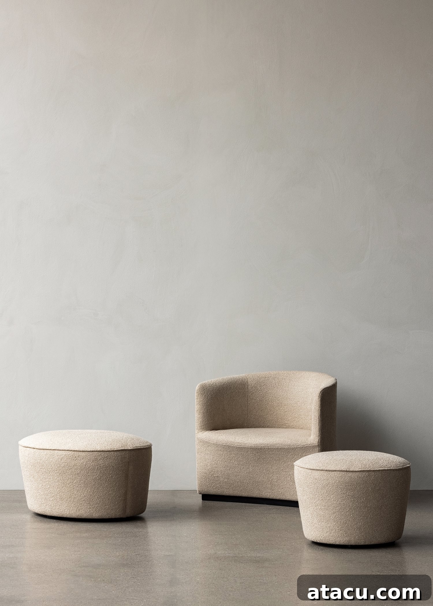 The stylish Menu Cairn Pouf, designed by Nick Ross, serving as a versatile footrest or extra seating in a contemporary living space.