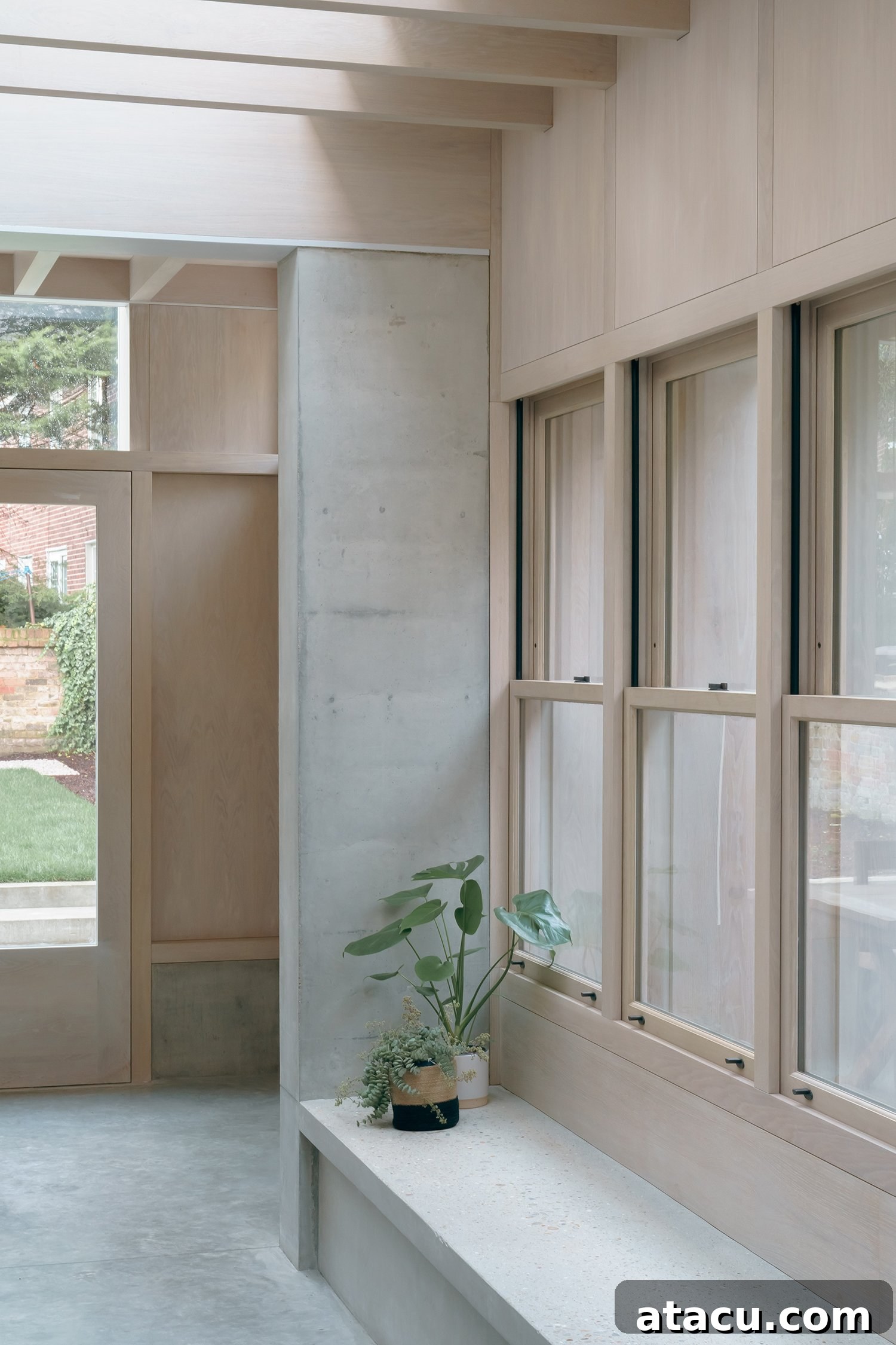 Interior view of the open-plan living and dining area with concrete elements
