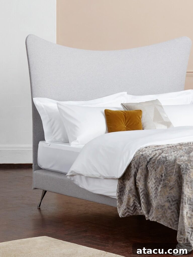 Close-up of luxurious high thread count white bed linen, highlighting its smooth texture and premium quality.