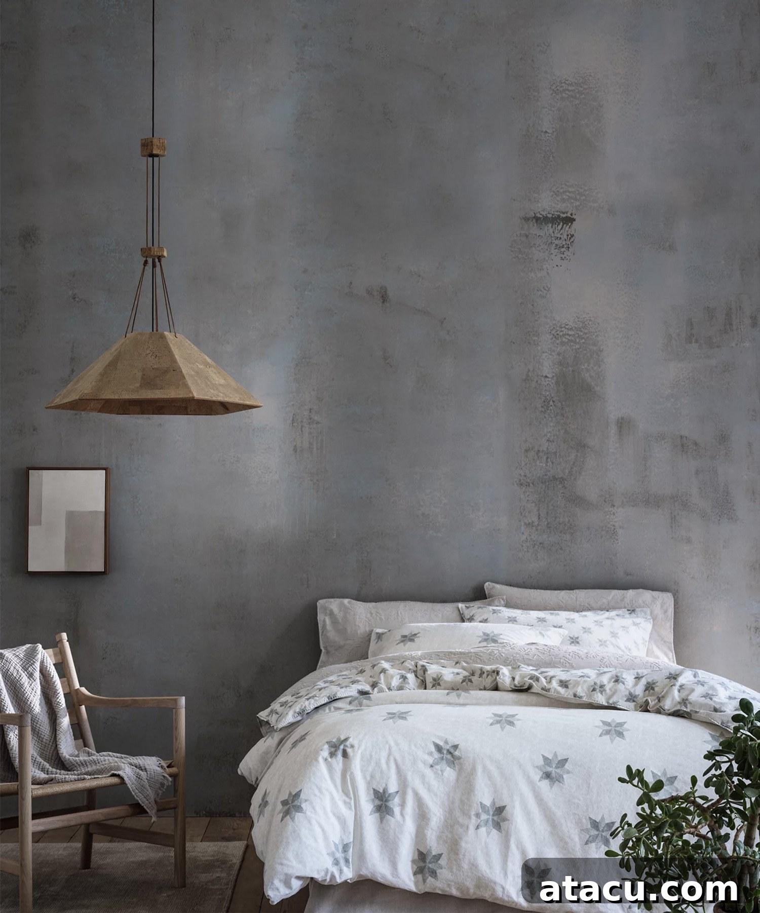 A bedroom with grey walls and white bedding with a star motif.
