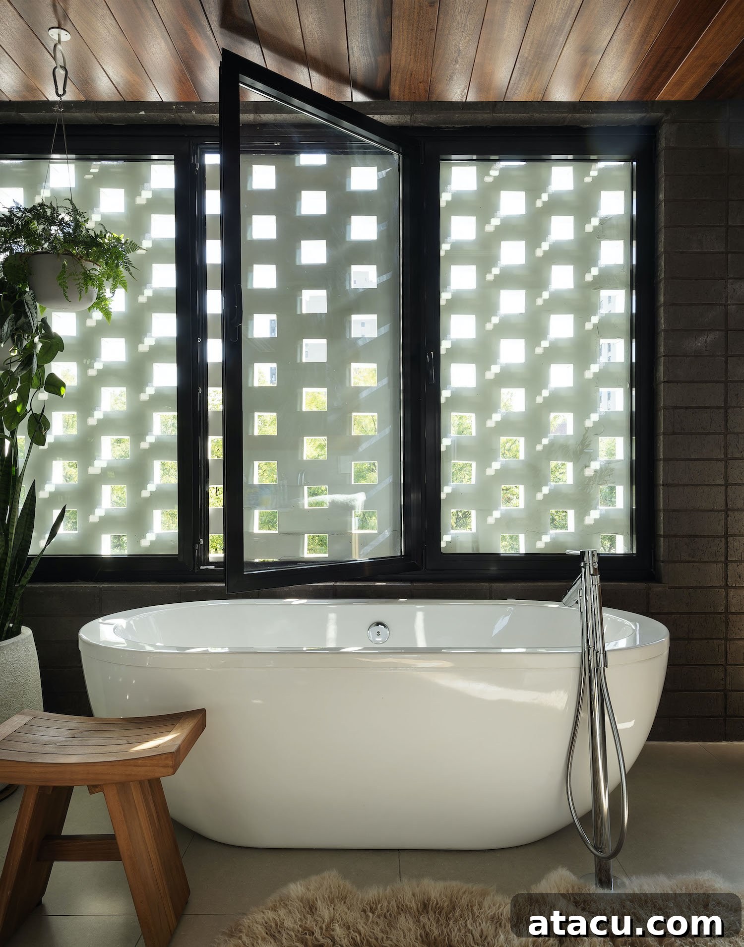 Luxurious master bathroom with a large soaking tub, natural stone finishes, and warm lighting.