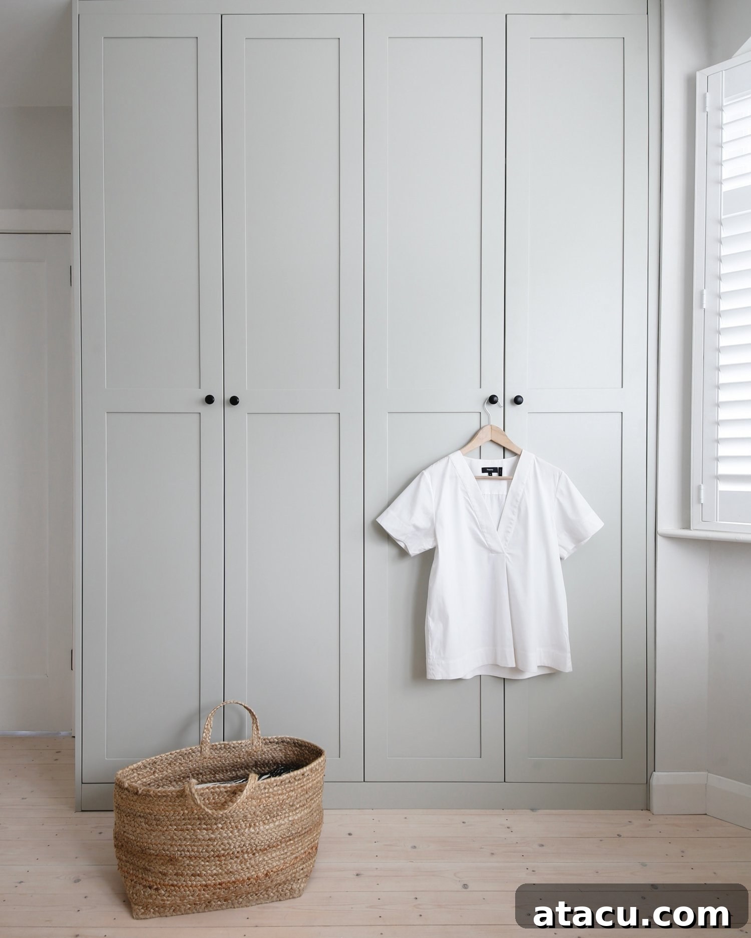 Stylish fitted wardrobes with elegant handles, complementing modern bedroom decor.