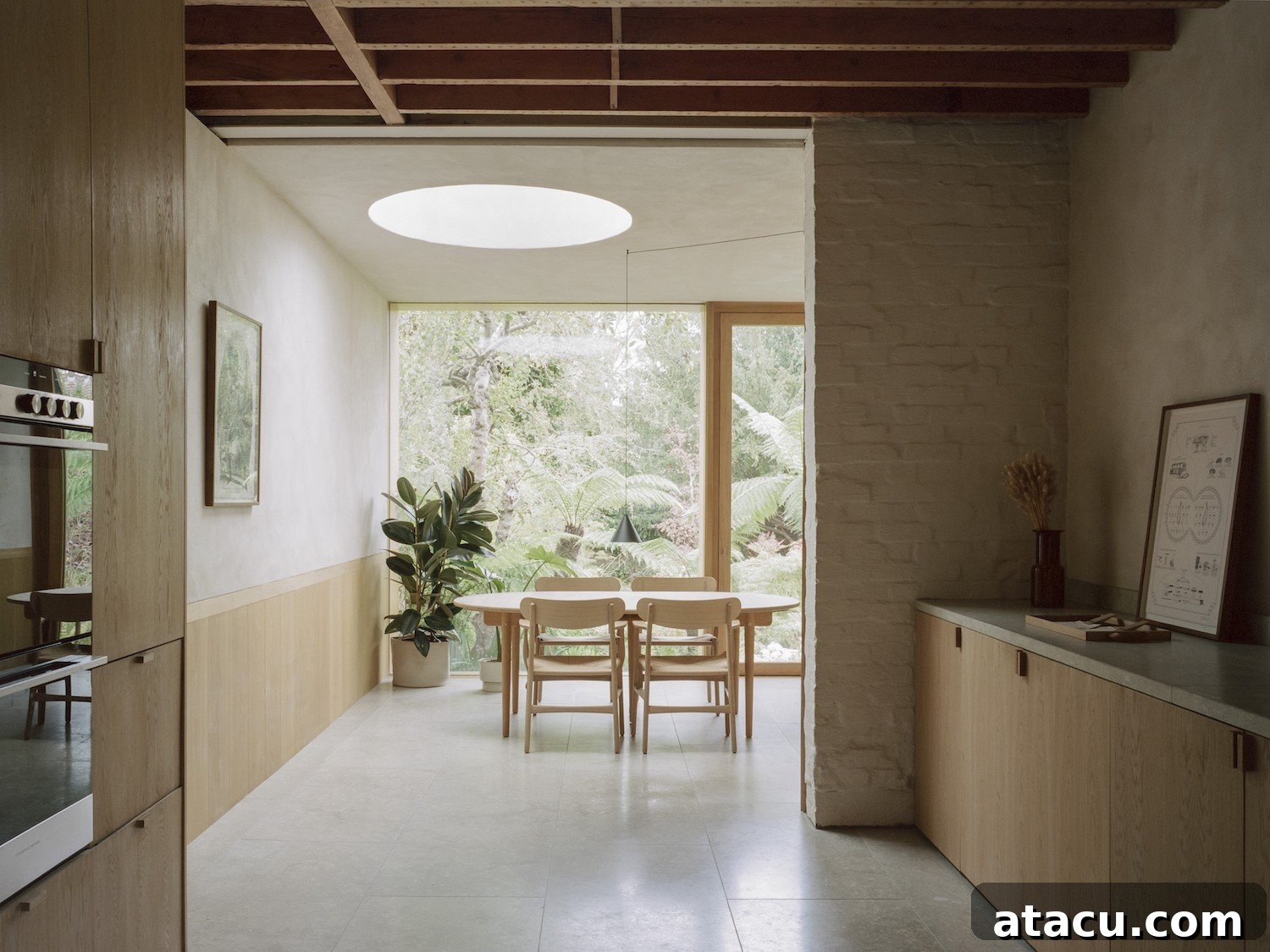 A London terraced house interior with a contemporary architectural design, featuring exposed brick and abundant natural light.