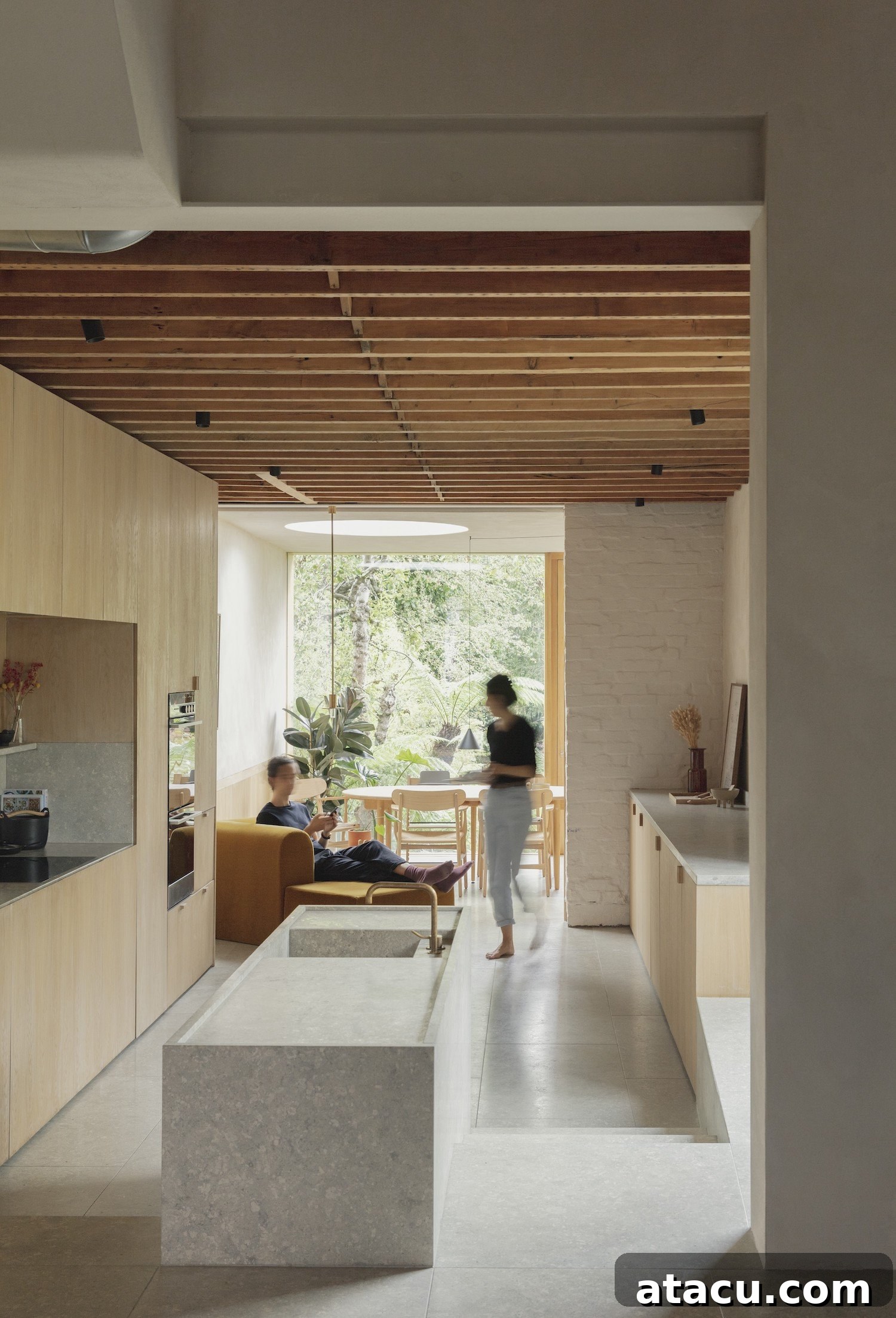 A modern kitchen and dining extension integrated into a traditional terraced house, showcasing clean lines and bright, open spaces ideal for London living.