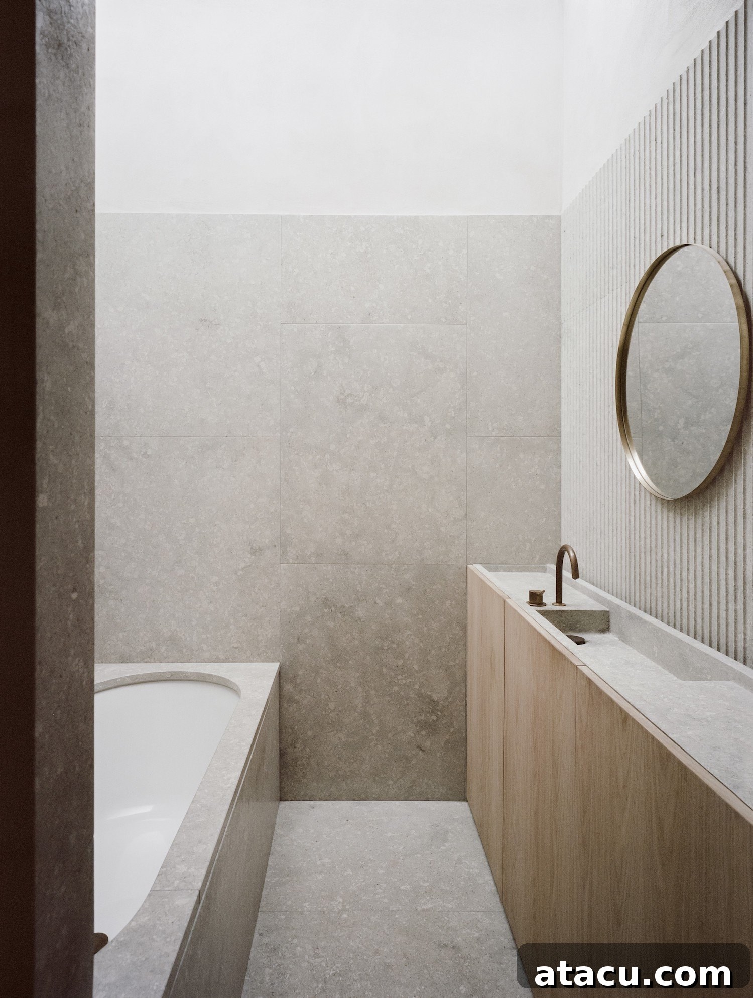 A sleek and contemporary minimalist bathroom featuring elegant grey marble tiles, a modern wooden vanity unit, and subtle lighting, creating a spa-like atmosphere.