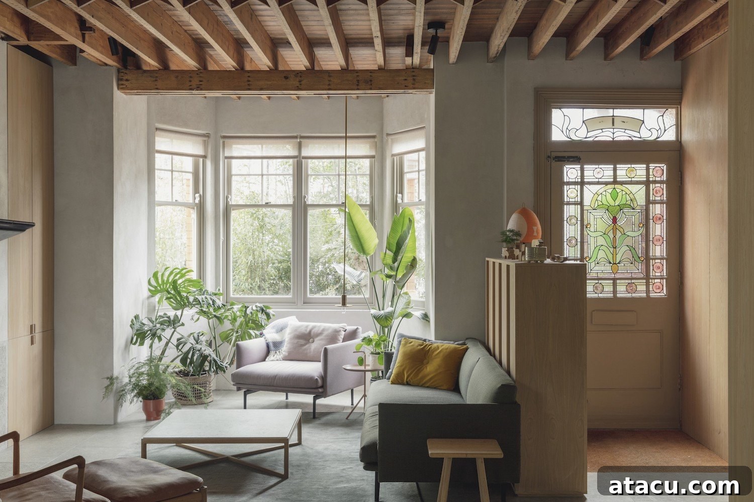 An open-plan living space in a London terraced house, featuring modern architectural lines, an abundance of natural light, and a minimalist interior design aesthetic.