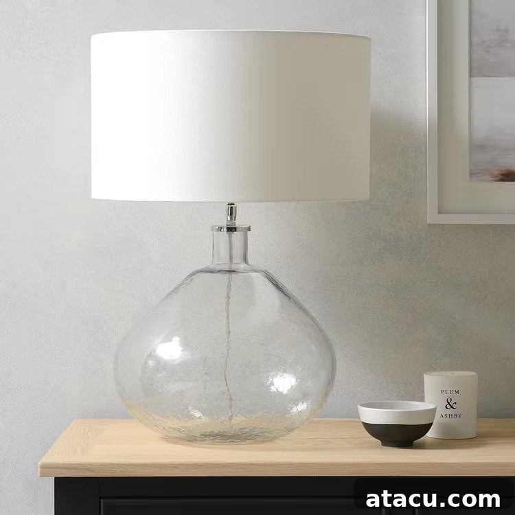 Textured glass table lamp handmade in India with a white handloom cylinder shade.