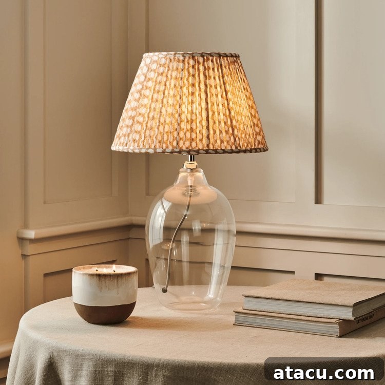 Shaftesbury glass table lamp from Neptune with a hand-blown base and a warm brown shade featuring a honeycomb pattern.
