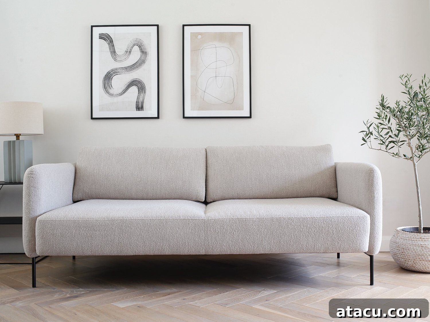A beige modern 3 seater sofa bed in a living room.
