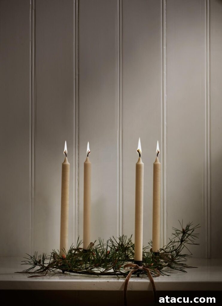 A simple yet elegant natural foliage wreath twisted around a classic candleholder, adorned with four lit candles for a warm Christmas glow.