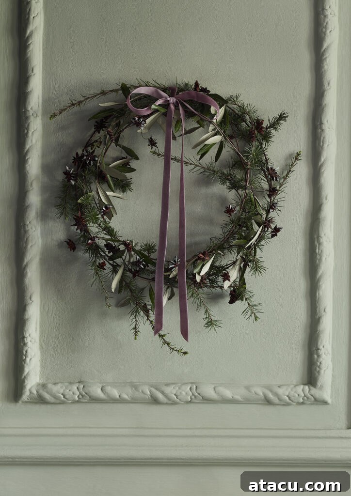 A rustic natural wreath displayed against a wall painted in 'Terre Verte' by Annie Sloan, highlighting its organic beauty.