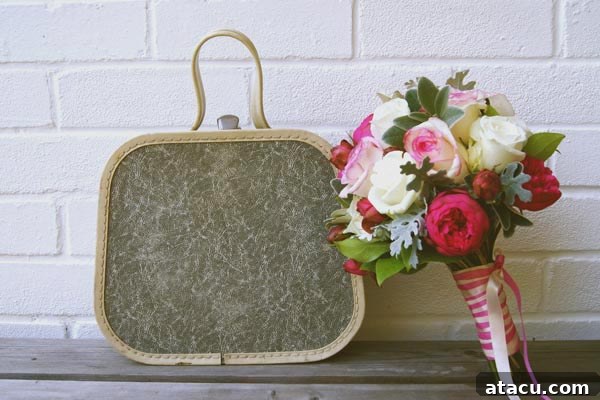 A detailed close-up of a stylish vintage vanity case, showcasing its textured surface, classic metal clasps, and elegant handle, perfect for adding a retro touch to any decor.