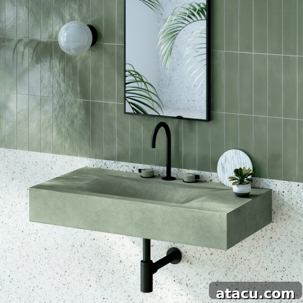 A contemporary Kast concrete wash basin in a muted sage green, showcasing modern material and color trends.