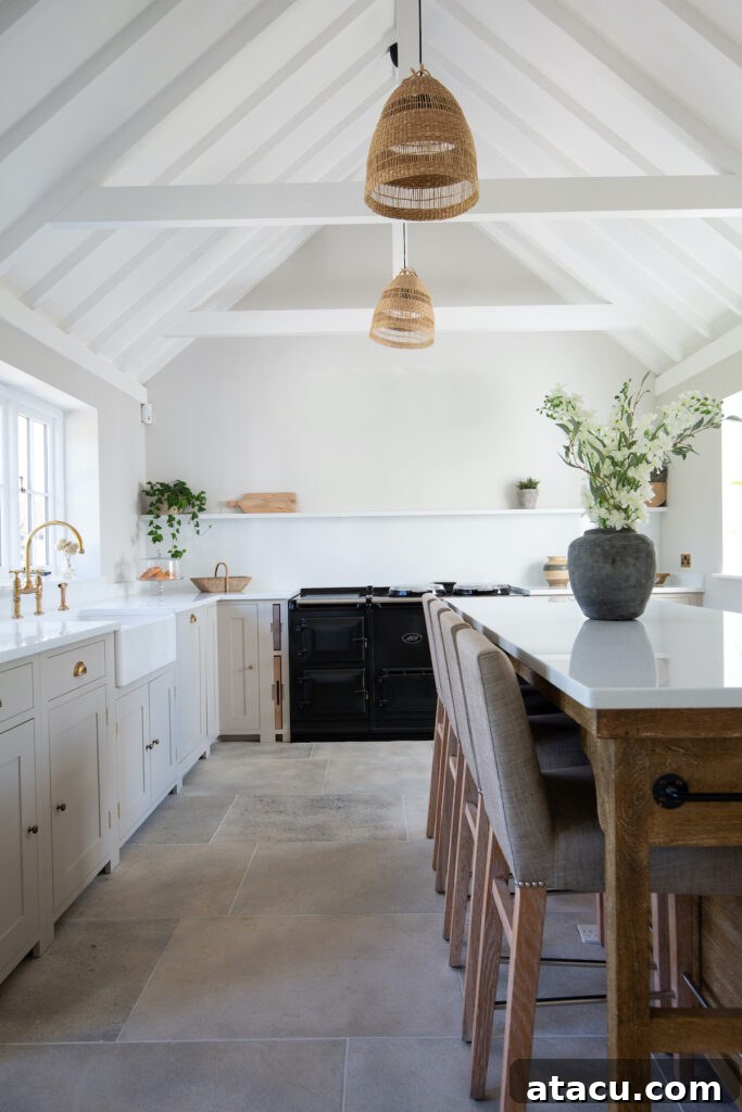 A country farmhouse style kitchen with cream cabinets and tumbled limestone flooring.