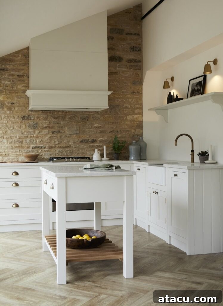 Elegant Shaker style cream kitchen with off-white cabinets and a warm stone accent wall.