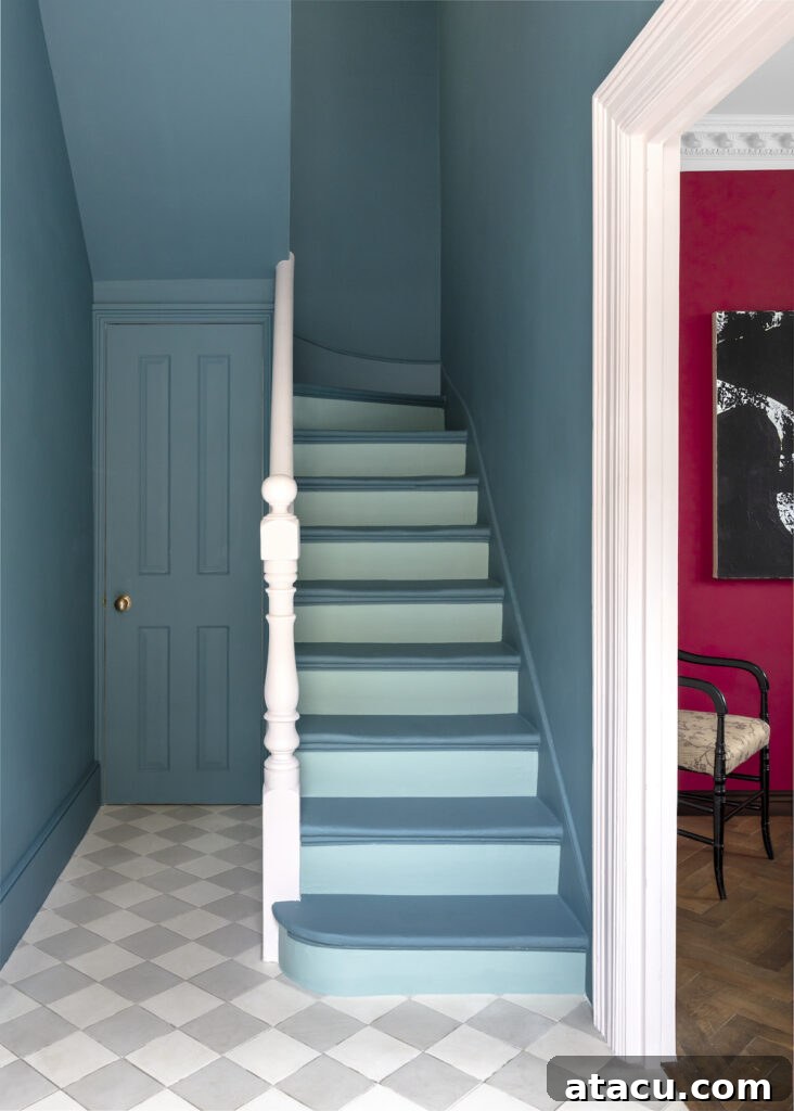 Hallway with a bold blue staircase and contrasting red wall, ideal for those seeking stylish hallway, stairs and landing ideas with a modern twist.