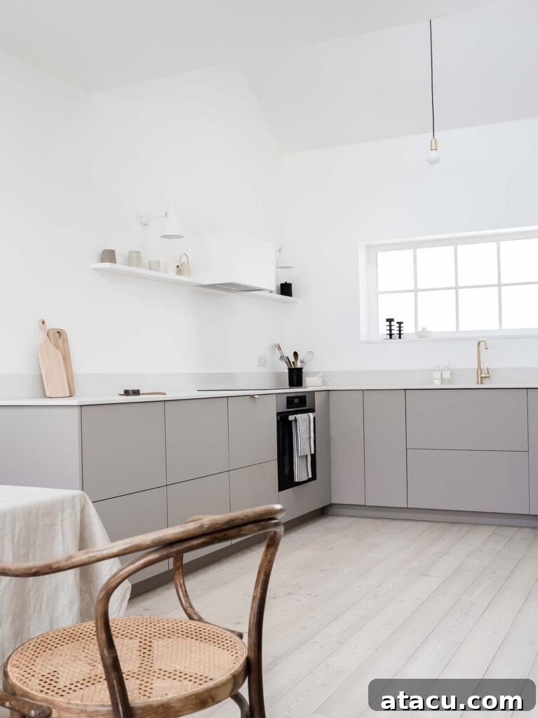 21 Jaw-Dropping Kitchen Extension Designs 2 A contemporary minimalist kitchen extension with a pitched ceiling, clean lines, and ample natural light.