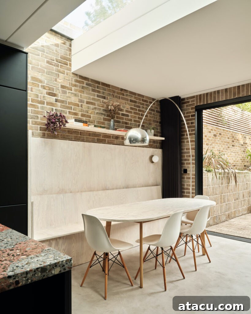 21 Jaw-Dropping Kitchen Extension Designs 12 Comfortable built-in bench seating in a modern kitchen extension, offering a space-efficient dining solution.