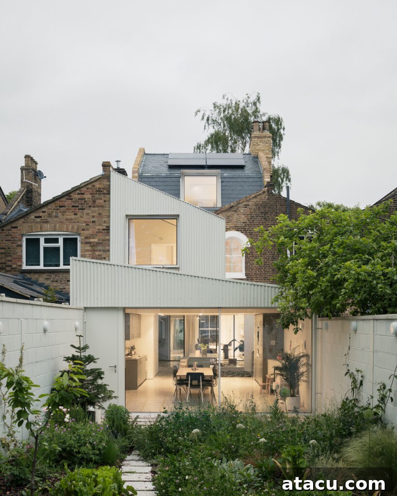 21 Jaw-Dropping Kitchen Extension Designs 13 A stunning white home extension strategically designed to maximize panoramic garden views, creating a serene backdrop.