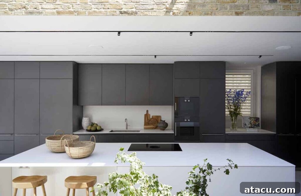 21 Jaw-Dropping Kitchen Extension Designs 14 A large, beautifully designed kitchen island serving as the focal point in a modern kitchen extension.