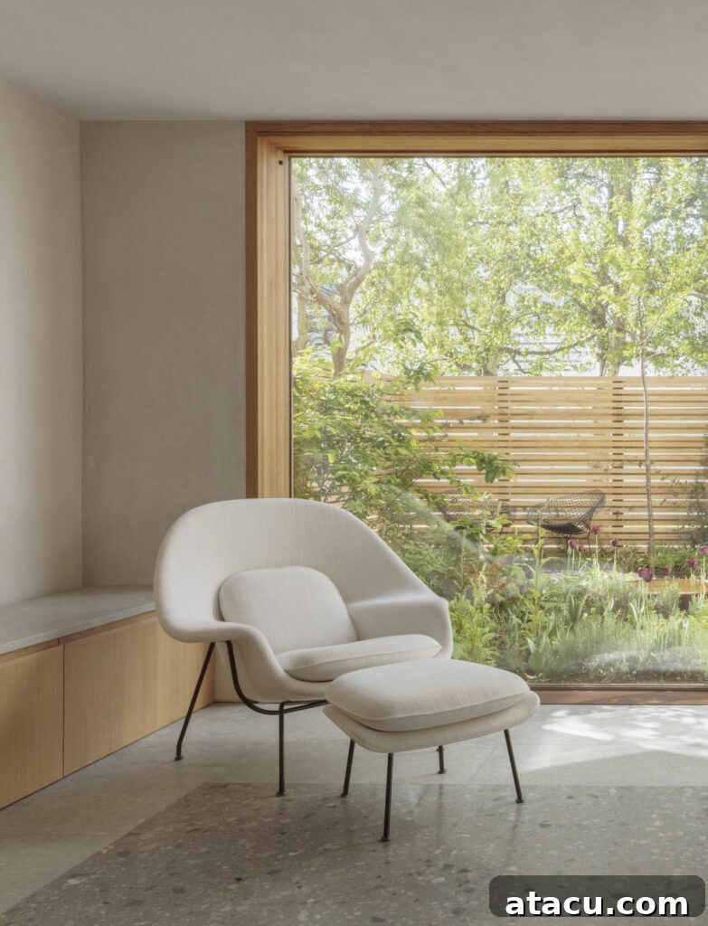 21 Jaw-Dropping Kitchen Extension Designs 18 A modern home extension featuring dramatic floor-to-ceiling glass windows, offering expansive views and abundant natural light.