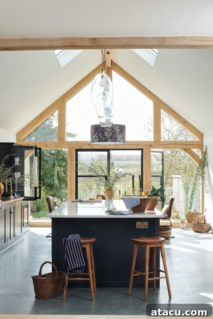 21 Jaw-Dropping Kitchen Extension Designs 3 A light kitchen extension with a vaulted ceiling and elegant doors leading out onto a lush garden, enhancing natural light and spaciousness.