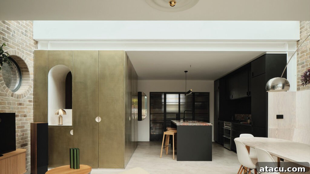 21 Jaw-Dropping Kitchen Extension Designs 5 A modern open-plan kitchen extension showcasing brass clad storage cupboards, adding a touch of luxury and warmth.