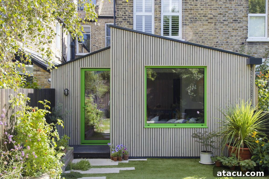 21 Jaw-Dropping Kitchen Extension Designs 6 A modern kitchen extension featuring bright green window frames, creating dynamic visual interest against neutral walls.