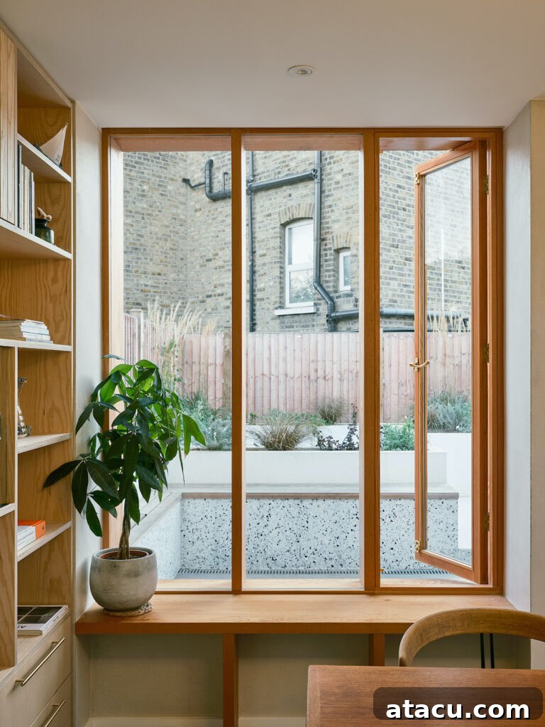 21 Jaw-Dropping Kitchen Extension Designs 7 A charming window seat integrated into a modern kitchen extension, perfect for reading and relaxation.