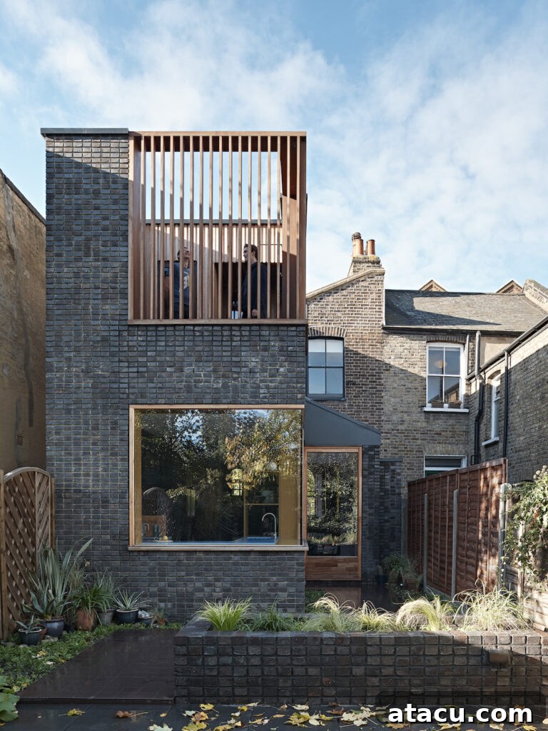 21 Jaw-Dropping Kitchen Extension Designs 8 A London home featuring a stylish roof terrace positioned above a modern kitchen extension, offering an elevated outdoor living space.