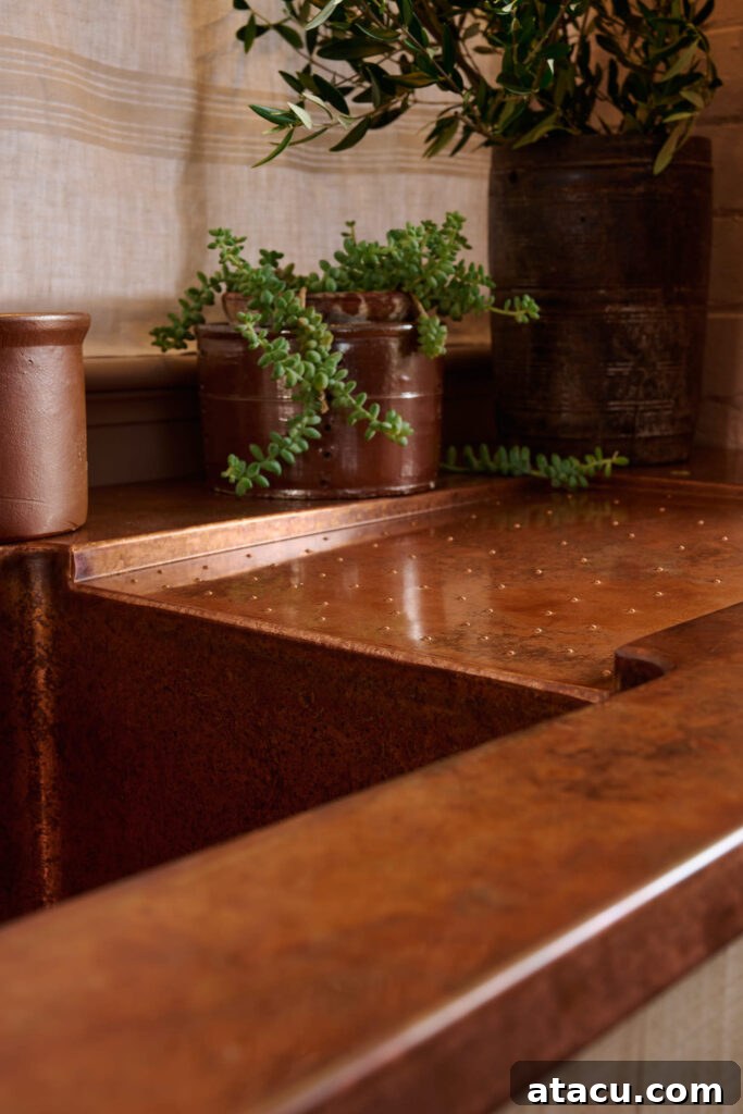 Elegant copper worktops reflecting natural light in a stylish kitchen setting.