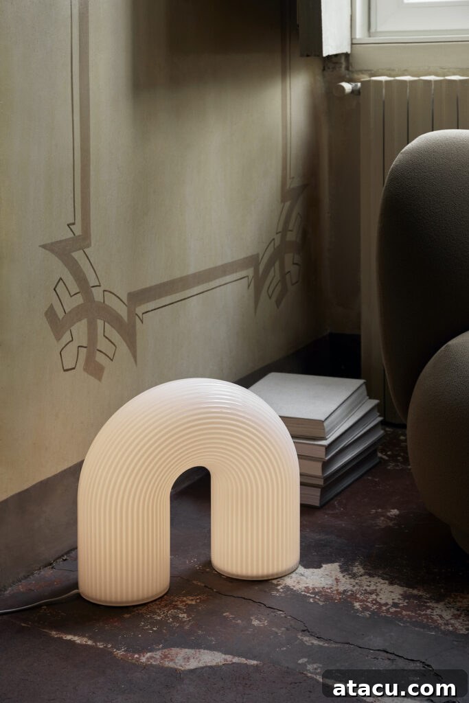 Transform Your Hallways: Inspiring Lighting Ideas for a Radiant Home 9 Vuelta floor lamp by Ferm Living, a sculptural floor lamp creating visual interest and ambient glow in a modern hallway.