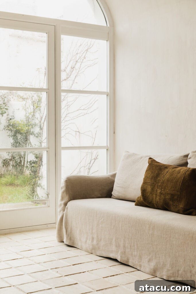 A modern rustic style interior with a beige sofa covered in linen slipcovers, inviting comfort.