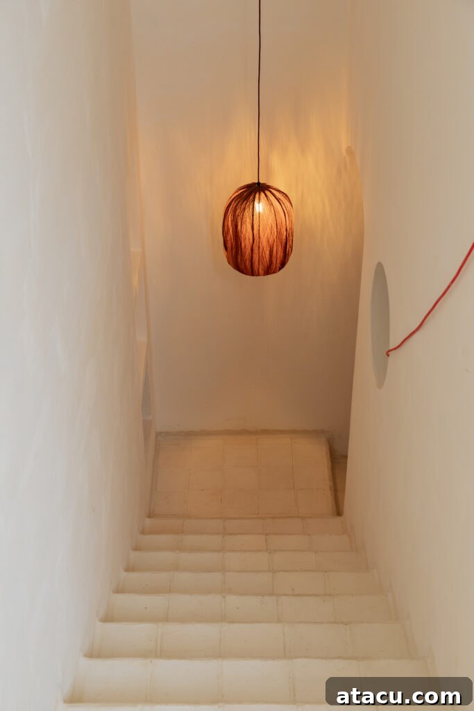 A fabric pendant light from Let's Pause hanging in the hallway of a modern rustic style interior.