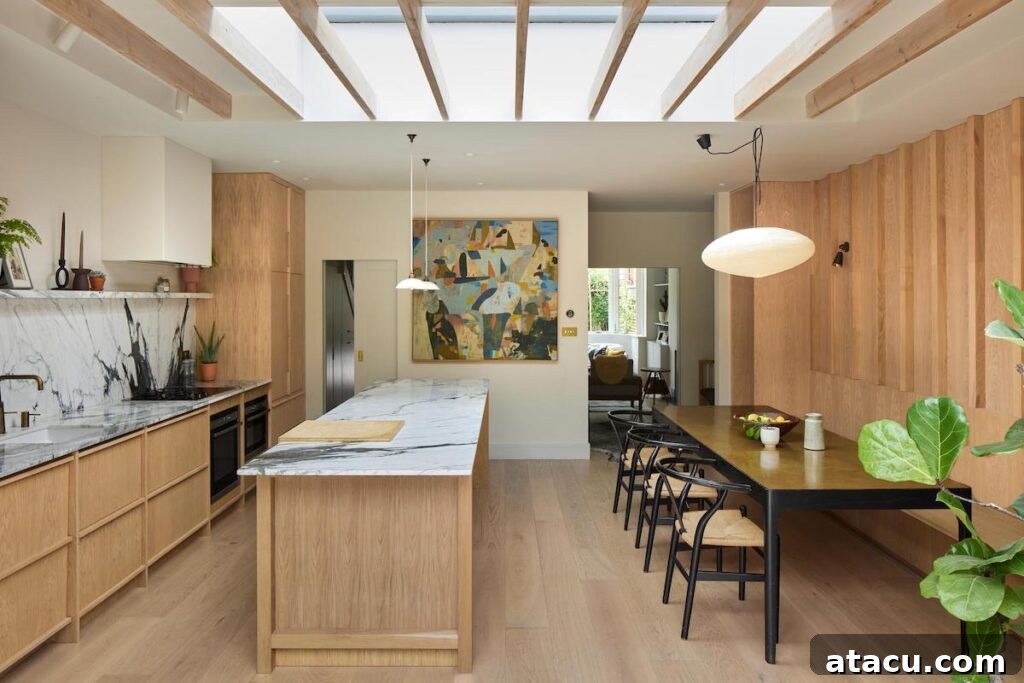 Integrated dining area in the bespoke Scandinavian kitchen, featuring a custom bench and wooden-clad wall.
