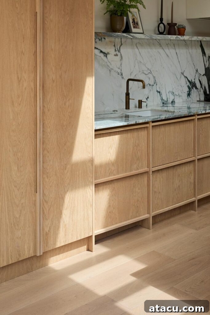 A detailed view of the custom cabinetry and hardware in the Scandinavian kitchen.