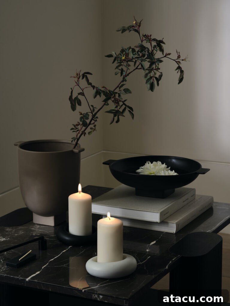 A curated display of elegant candles and sculptural ceramics arranged artfully against a soft, neutral backdrop, showcasing the collection's sophisticated decorative elements and tactile finishes.