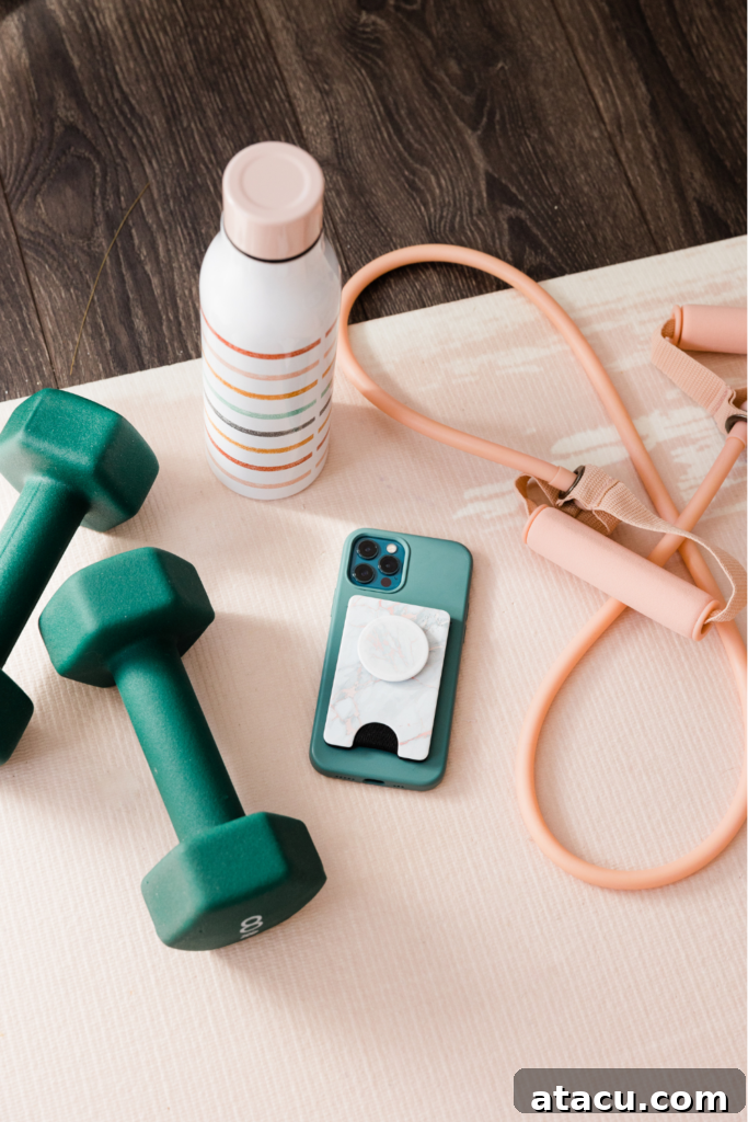 Home gym equipment - a dumbell, skipping rope and water bottle on a yoga mat.