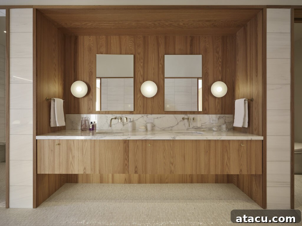 A luxury oak and marble modern bathroom with twin basins.