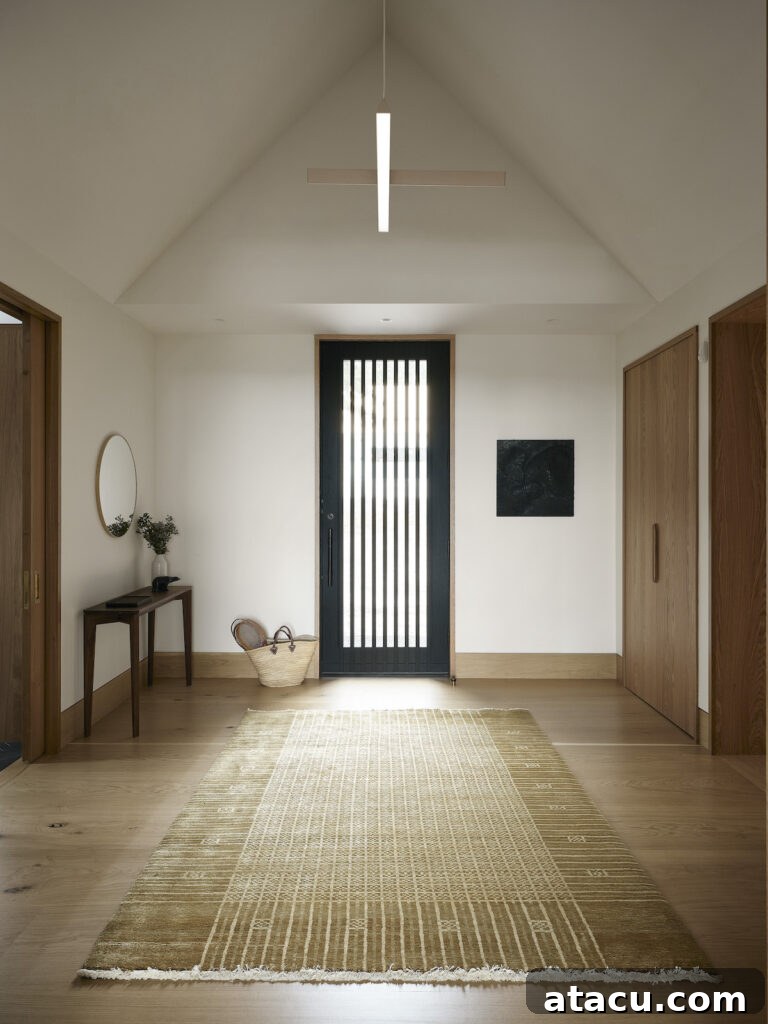 A pitched roof light-filled hallway in a luxury modern architect-designed home.
