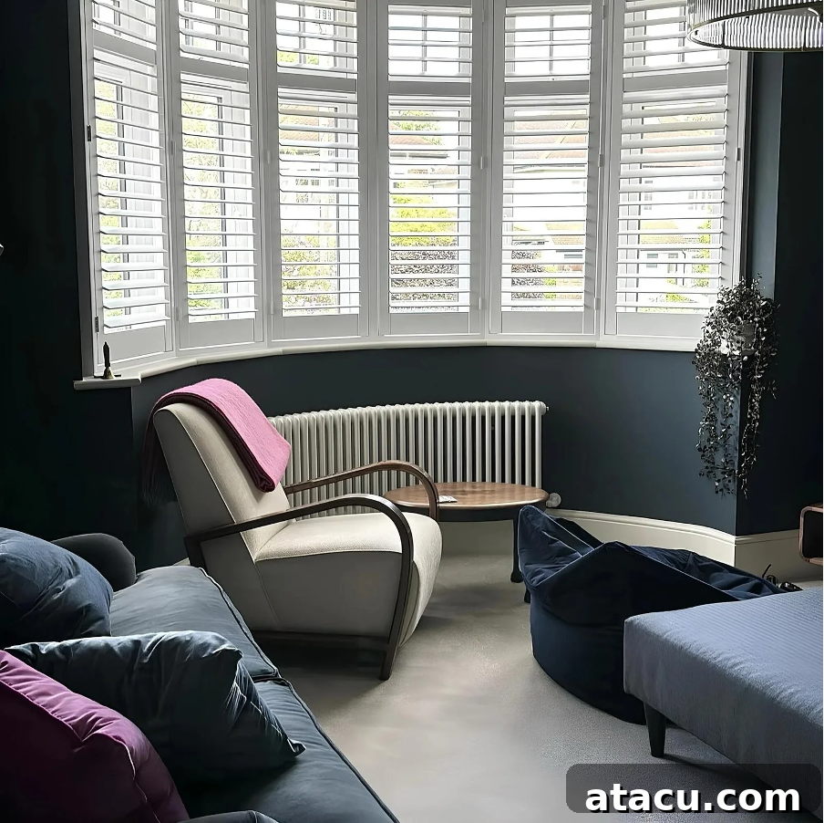 A curved bay window radiator in a blue living room.