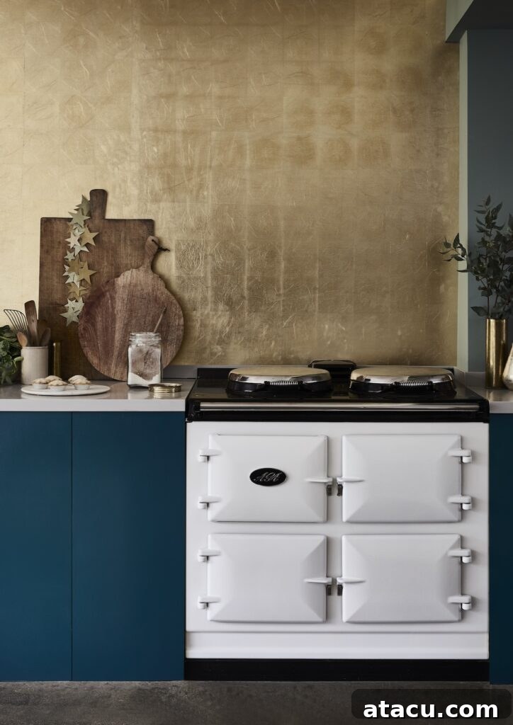 Painted kitchen cupboards in Aubusson Blue Chalk Paint by Annie Sloan with gilded backsplash.
