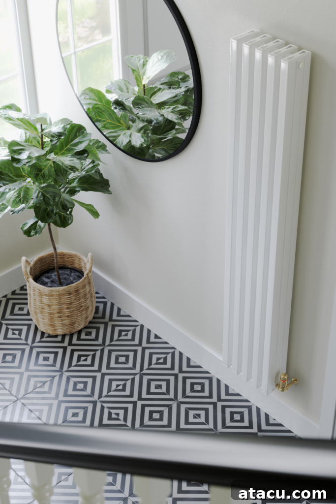 Bright hallway with a tall white radiator, leafy plant, and geometric tiles, demonstrating stylish home heating hacks.