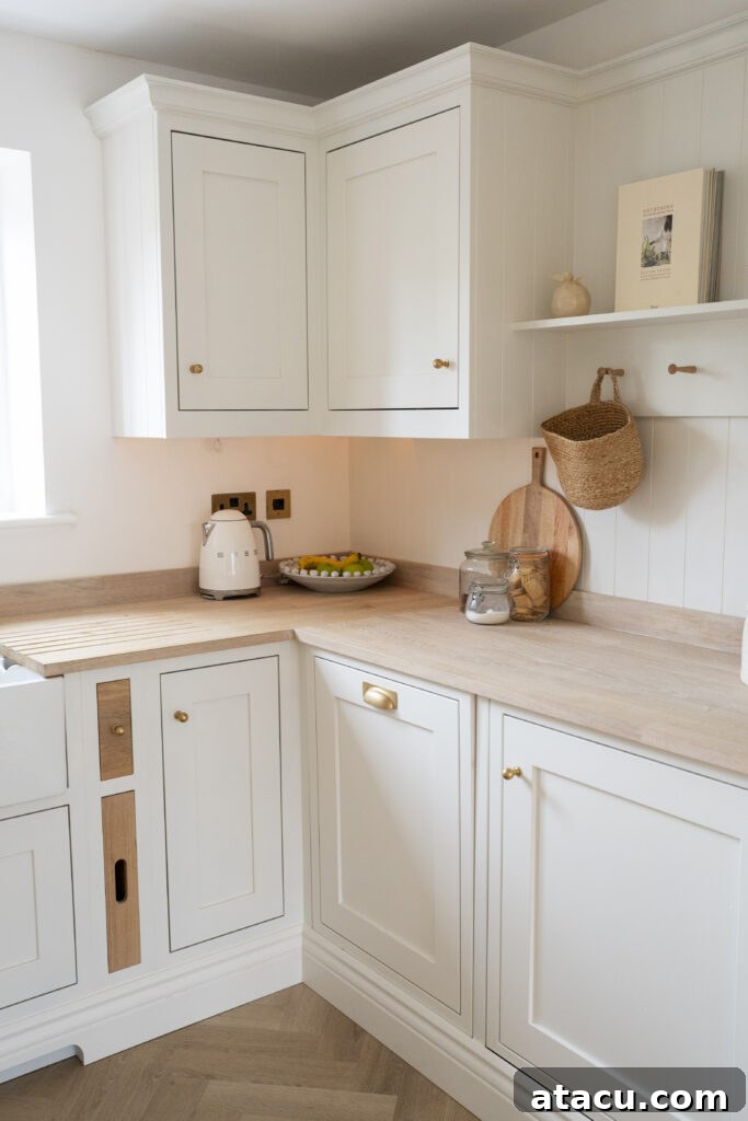 A cream small kitchen showcasing cream cabinetry, wooden countertops, and efficient use of corner space with stylish storage solutions, offering practical small kitchen ideas.