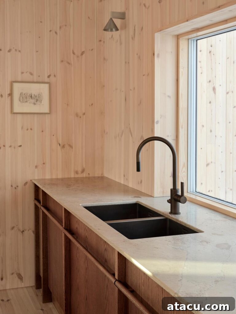 Close-up of elegant wood kitchen cabinets with a sleek black sink and faucet, contrasting beautifully against light wooden walls.