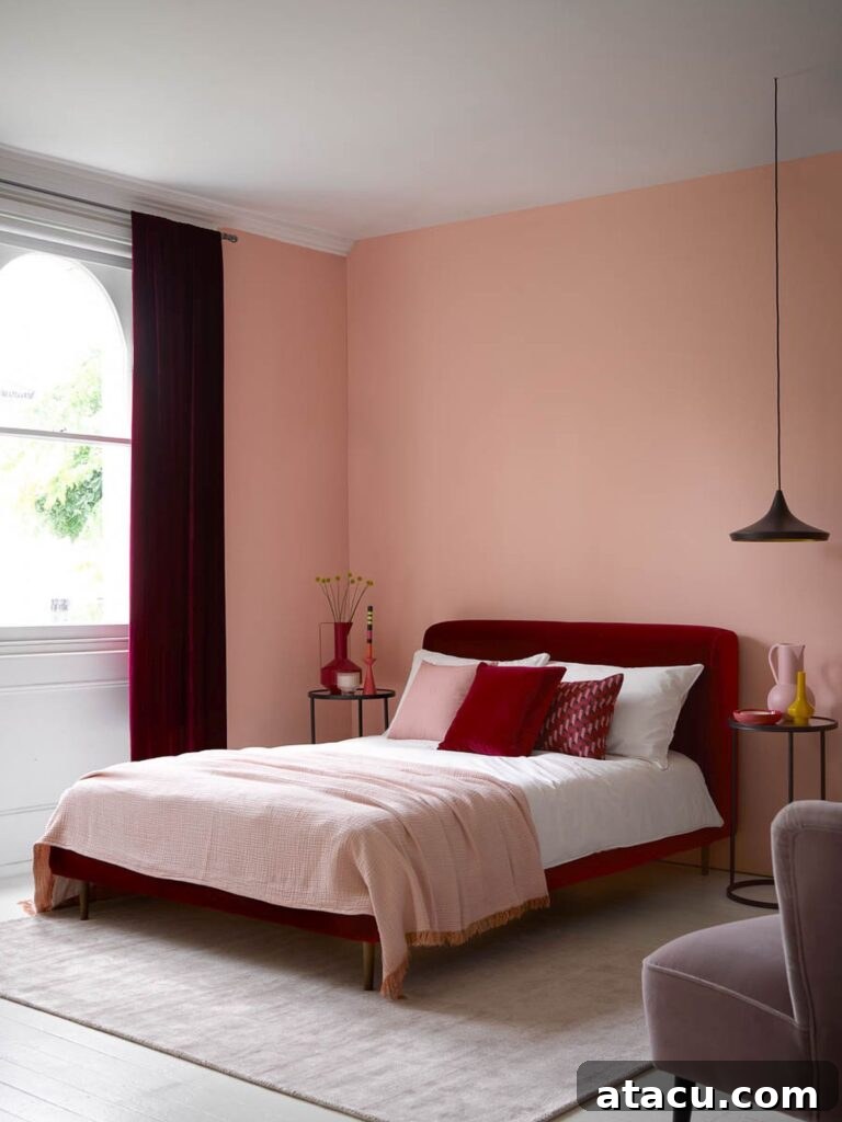 Ignite Your Interior: 8 Cherry Red Design Concepts 5 A modern bedroom featuring a rich cherry-red velvet headboard, soft pink walls, and deep red accents for a stylish and harmonious look.