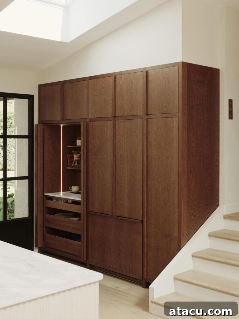 Custom wood-paneled cabinet wall featuring fully integrated appliance storage and convenient pull-out drawers, showcasing clever organization.